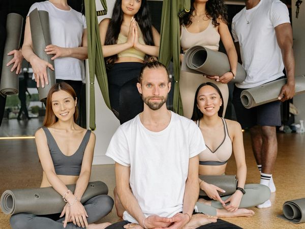 Diverse group of people smiling during a gentle yoga class.